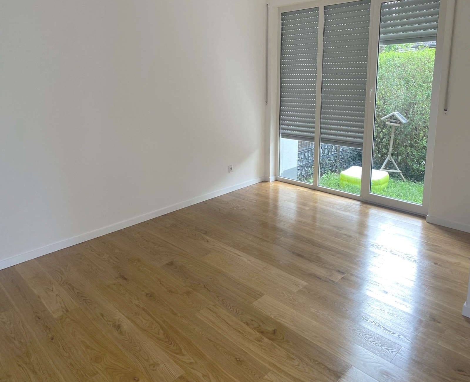 Lacquered oak parquet in a bathroom — a sealed, glued-down floor